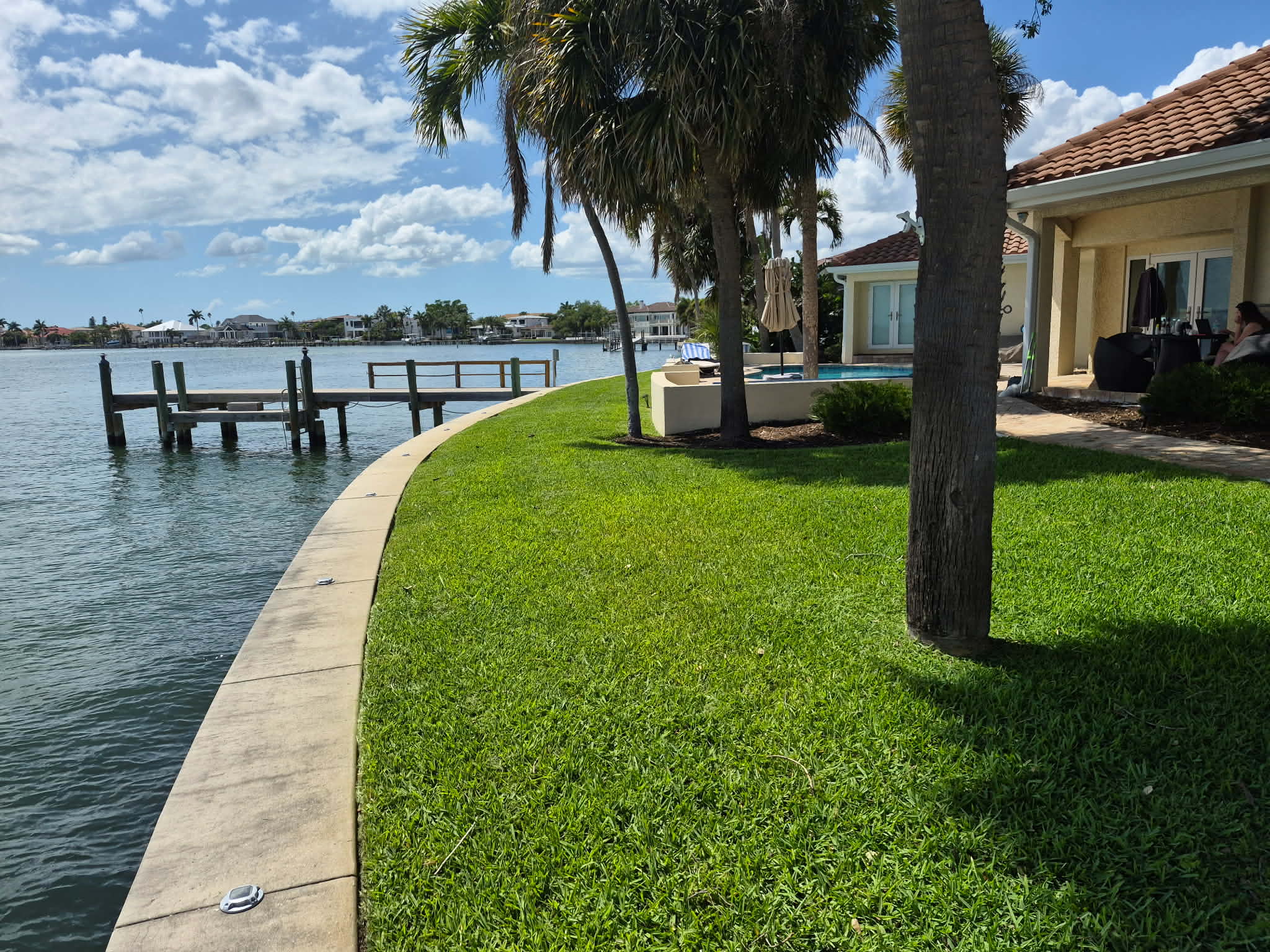 Waterfront property with lush maintained lawn